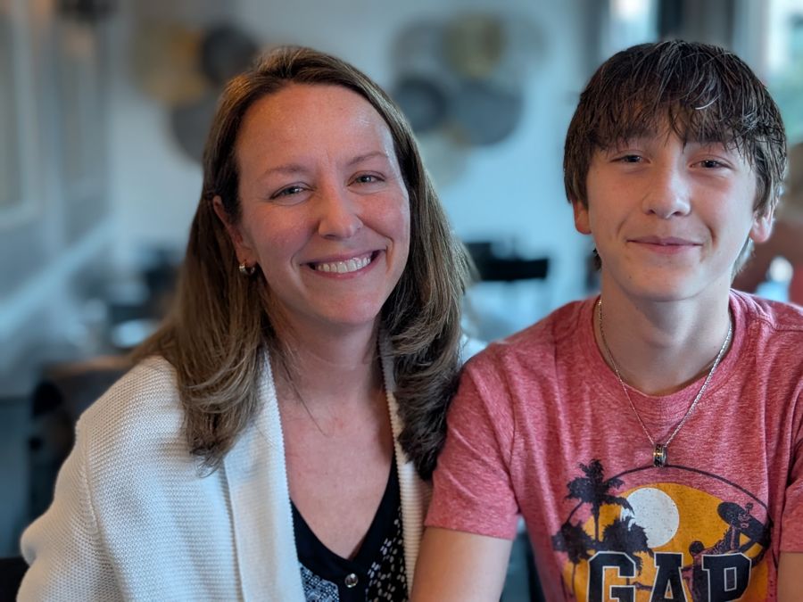 Two of Mark's family members smiling at a cafe